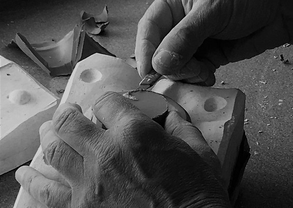 Julian Lamb Trimming a ceramic figure at Rye Pottery as it comes out of a plaster of paris mould