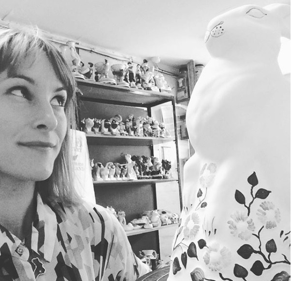 Illustrator Laura Gill eyeing up a Rabbit at Rye Pottery before she paints it